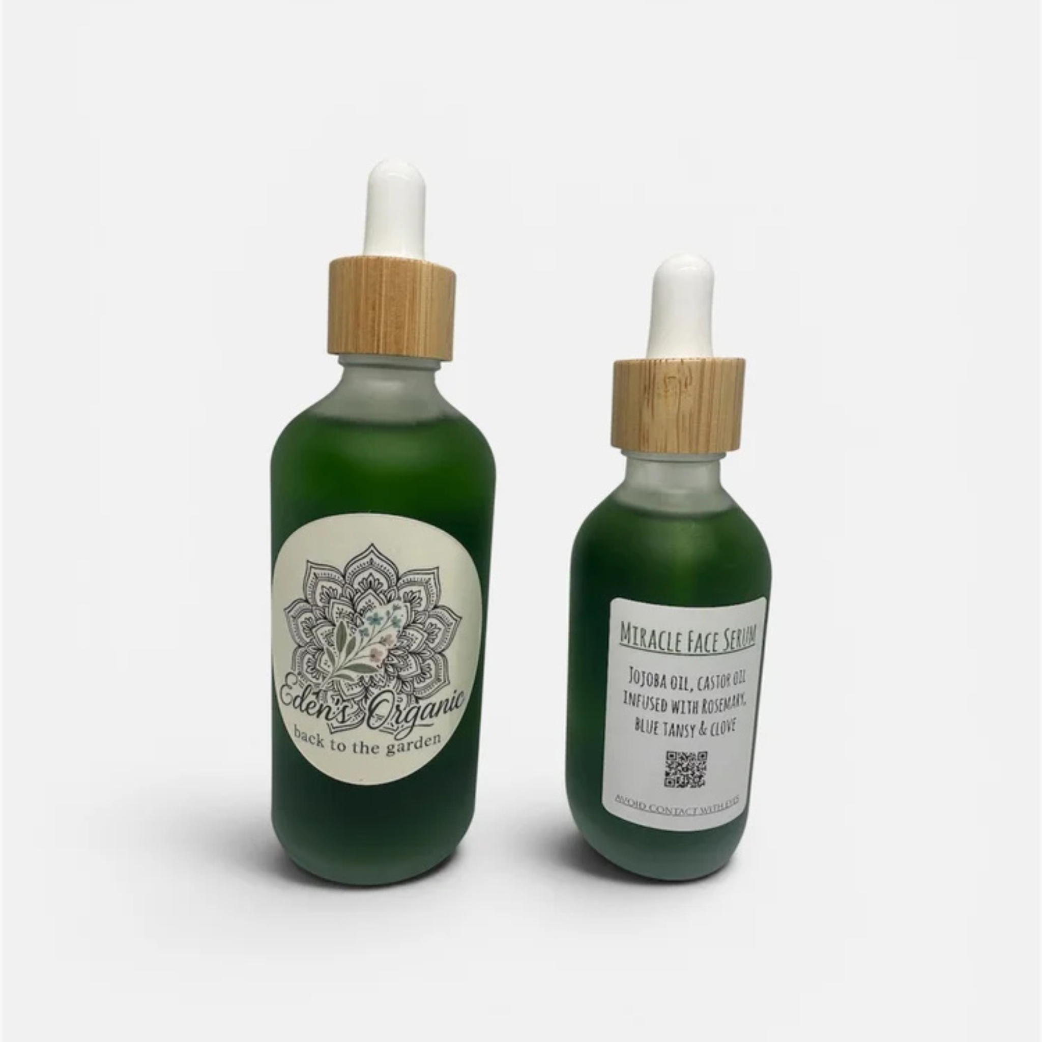 Two green bottles with bamboo caps on a white background